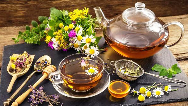 Dried tea herbs, citrus, and spices arranged for blending